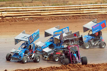 Avoiding a turn four tangle are Jimmy Brookens (11), Glen