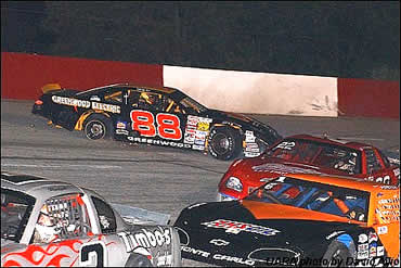 Gary Greenwood Jr spinning out while racing in a pack of traffic during the Anderson 150 UARA Late Model Stock Car feature at Anderson Motor Speedway