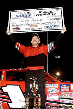 Tony Grady hoists the winner's check