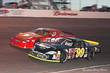 # 50 Jamey Caudill makes early attempts to take lead from # 99 Denny Hamlin.